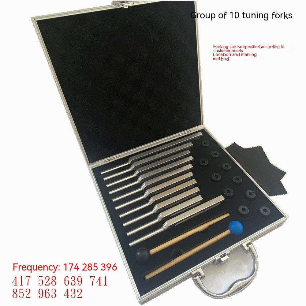 Open aluminum case with ten silver Solfeggio therapeutic tuning forks, rubber attachments, and mallets neatly arranged on a black foam interior.