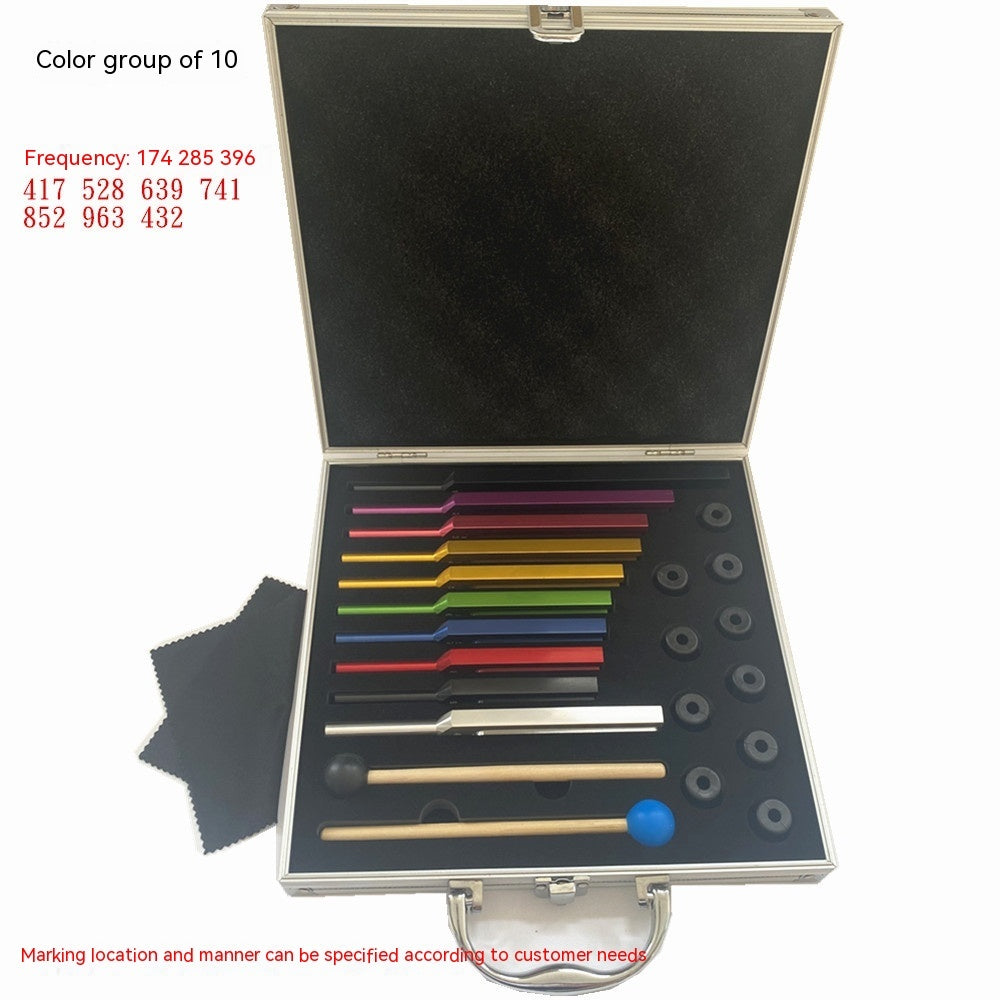 Open case displaying a set of ten colorful Solfeggio tuning forks with mallets and rubber attachments, arranged on black foam inside a metallic box.